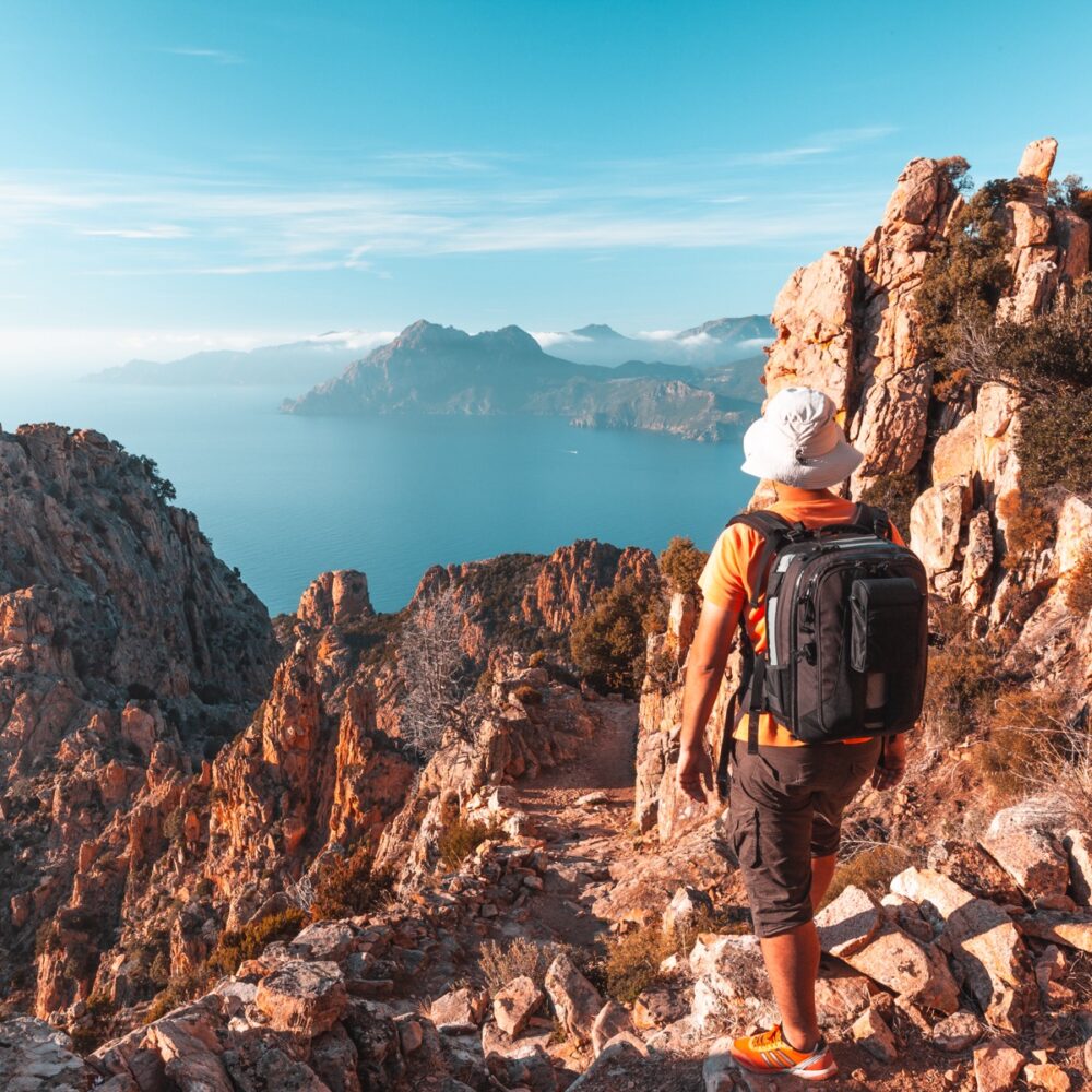 Hiker looking at the view at Calanques de Piana in Corsica, France